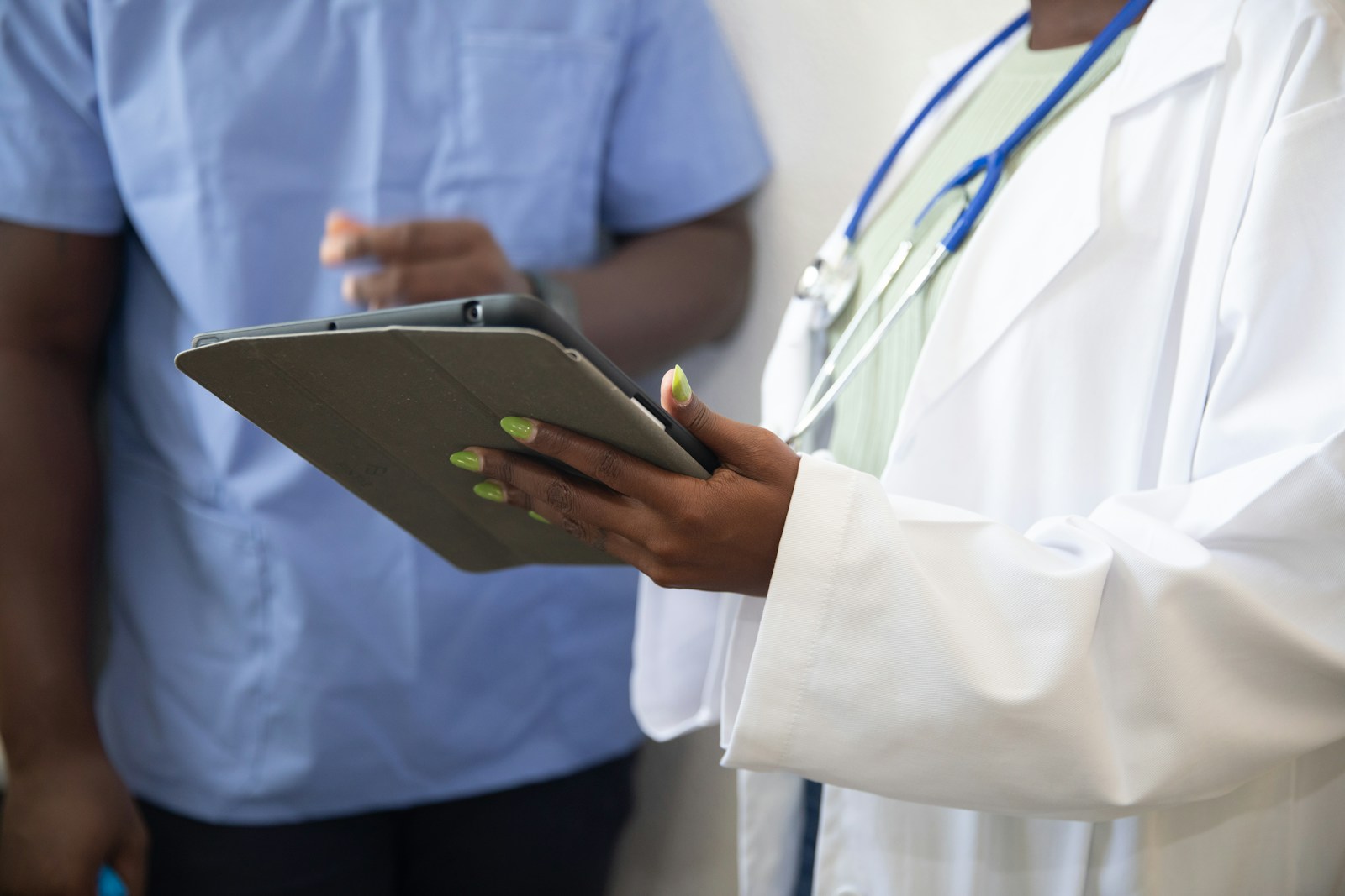 Stock image of healthcare professionals reviewing information on a tablet